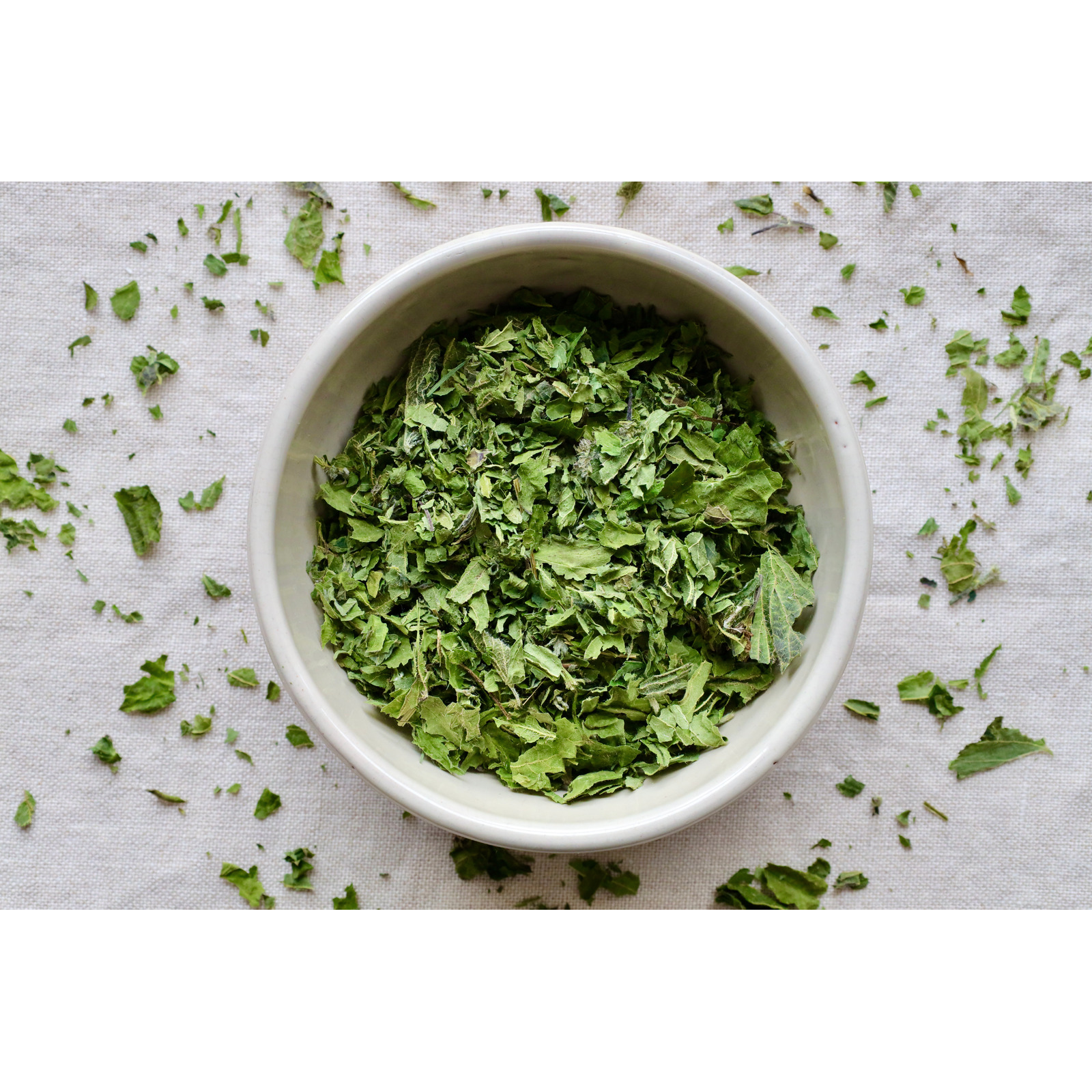 Organic nettle on display in bowl and on cloth