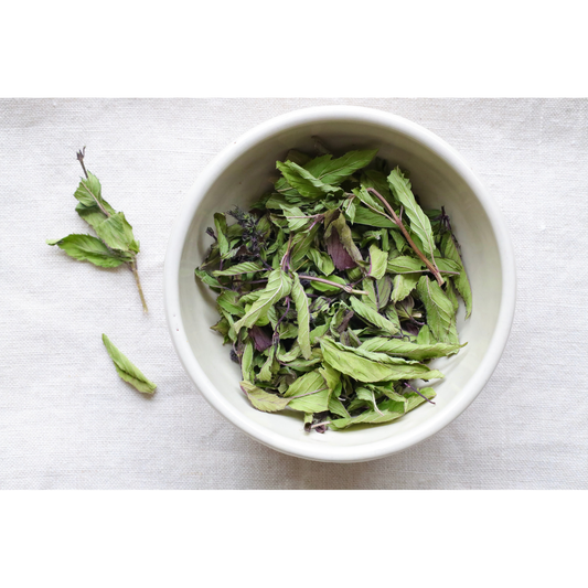 Photo of Organic peppermint whole leaf in bowl and on cloth on display