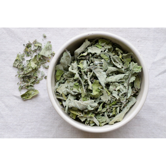 Organic Tulsi vana (Holy Basil) on display in bowl and on cloth